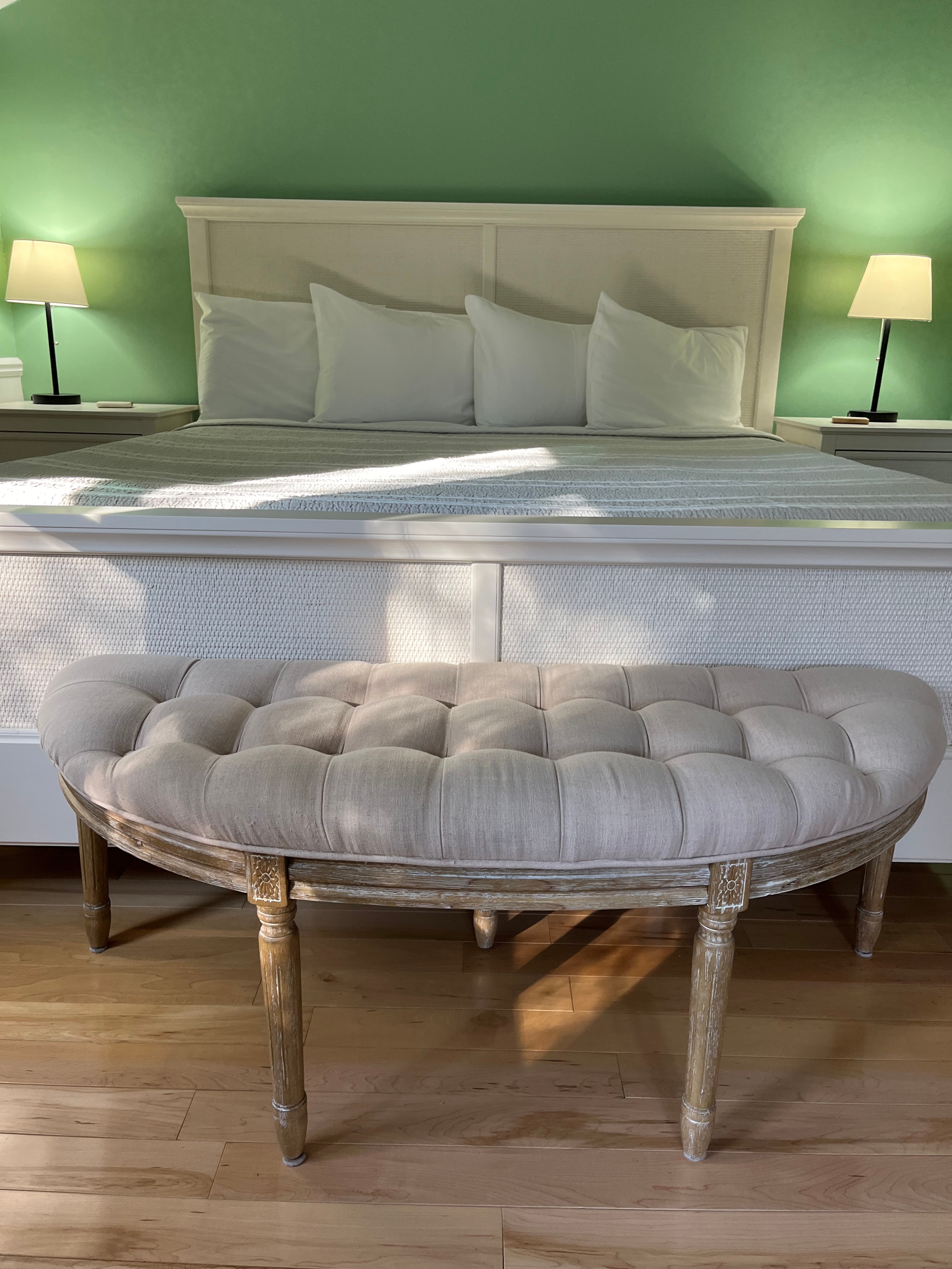 View of bed with nightstands and table lamps on both sides