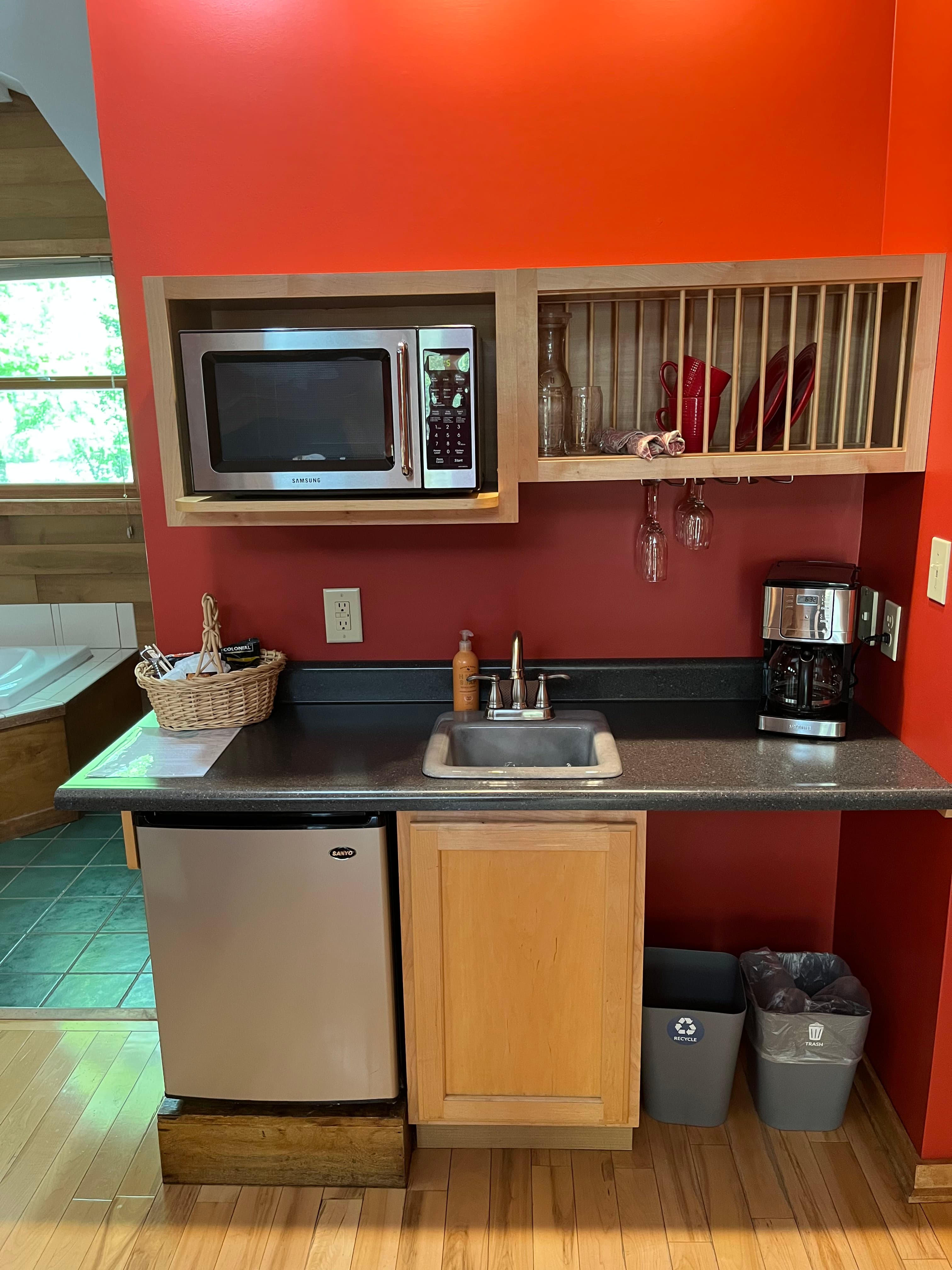 Kitchenette that includes dishes, coffee maker, sink, microwave and mini fridge